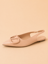 Pink flat shoe with a slingback design on a beige background