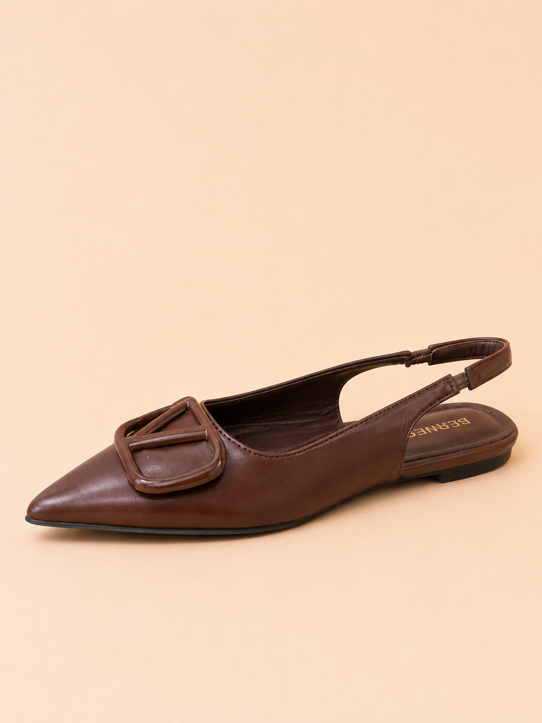 Brown leather slingback flat shoe on a beige background