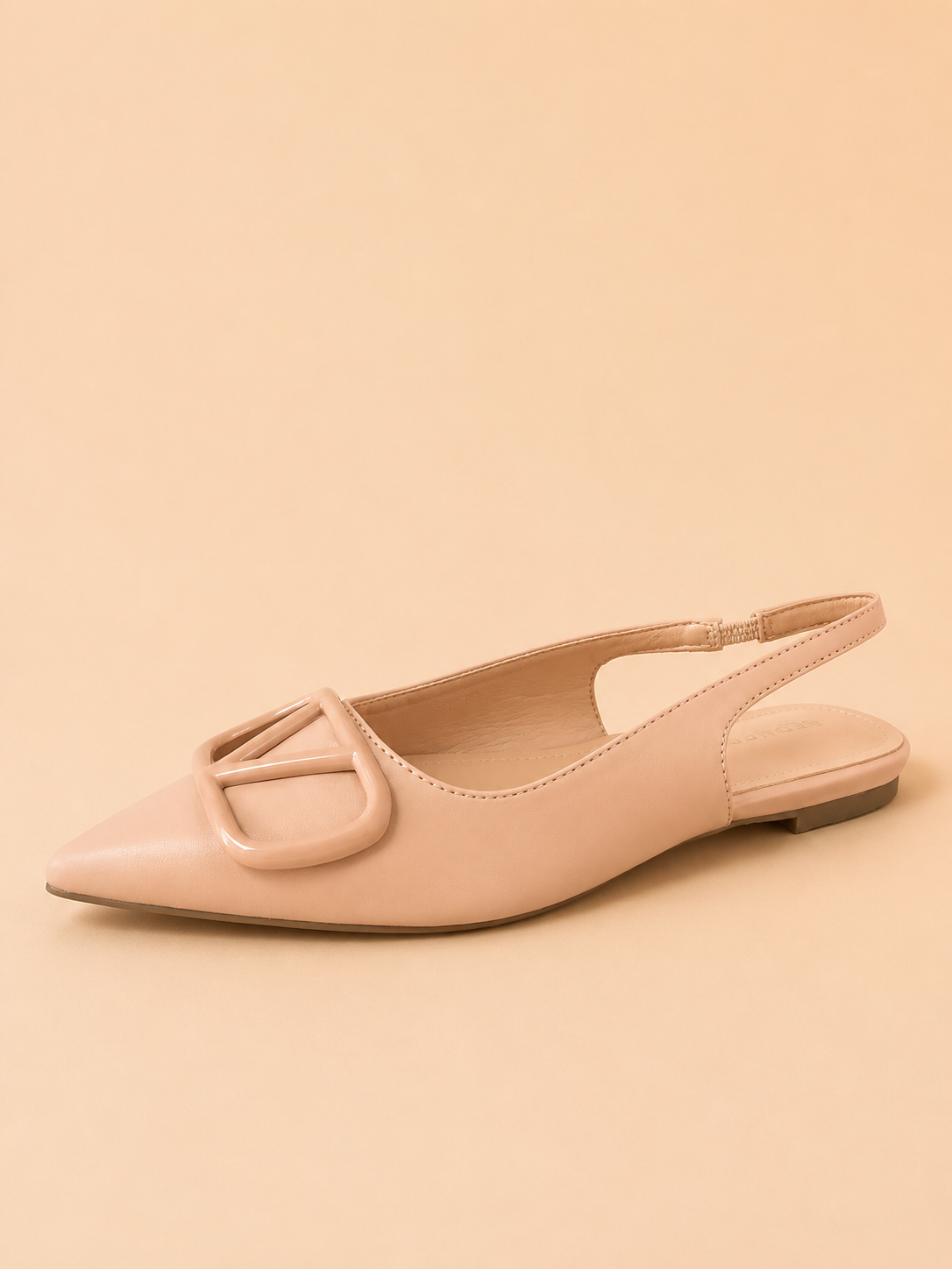 Pink flat shoe with a slingback design on a beige background