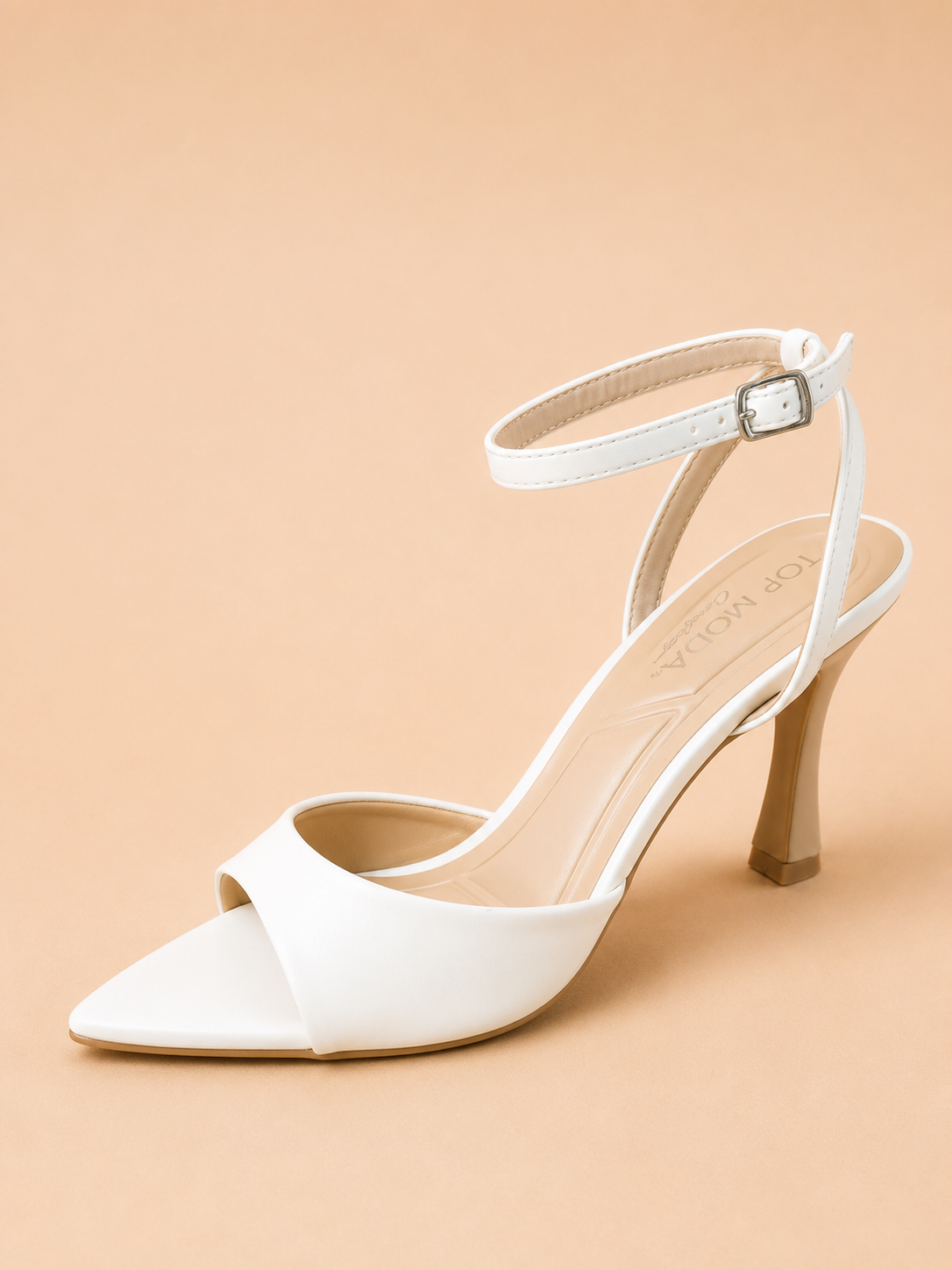 White high-heeled shoe on a beige background